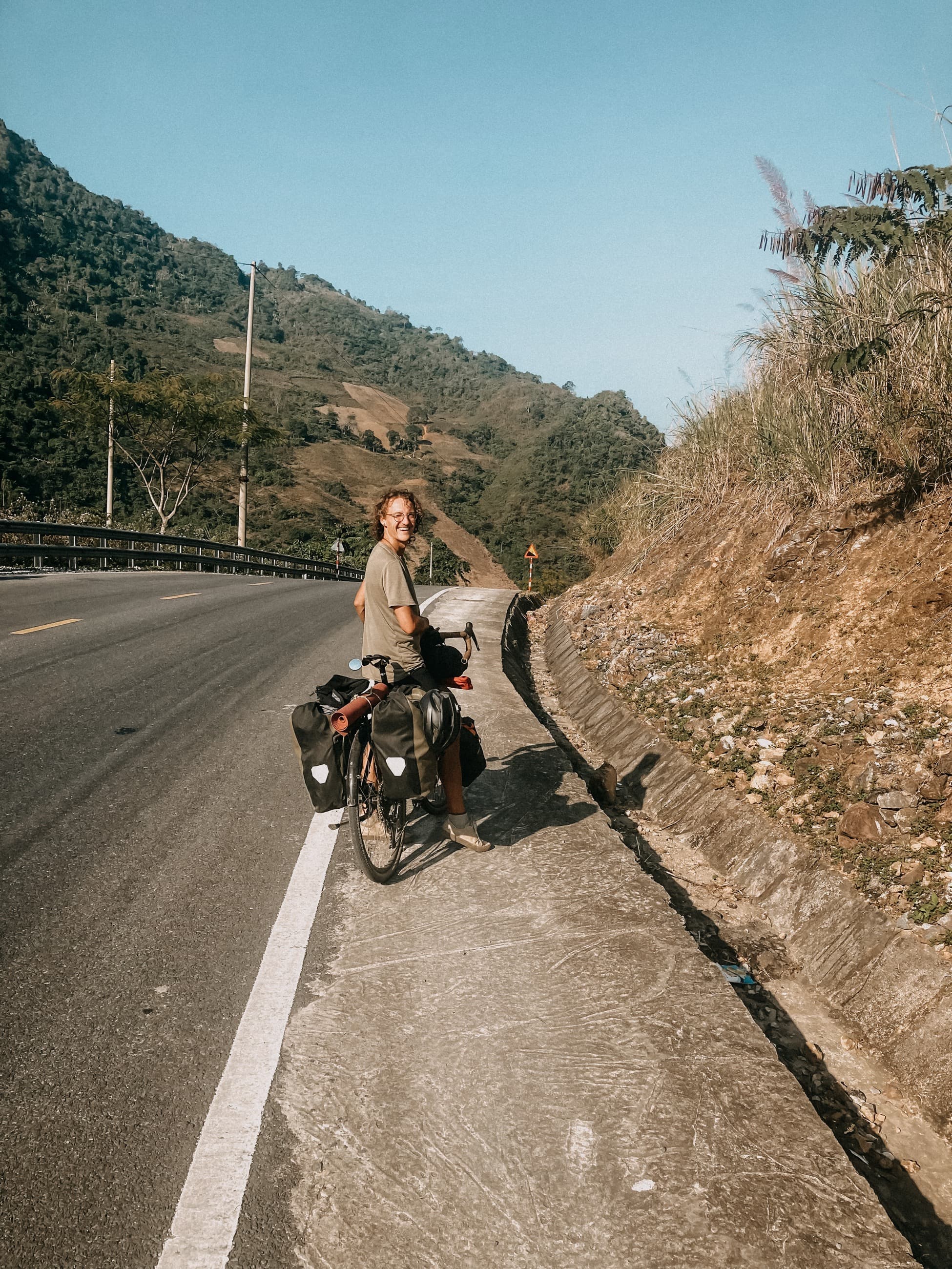 Markus on a loaded touring bicycle on a mountain road